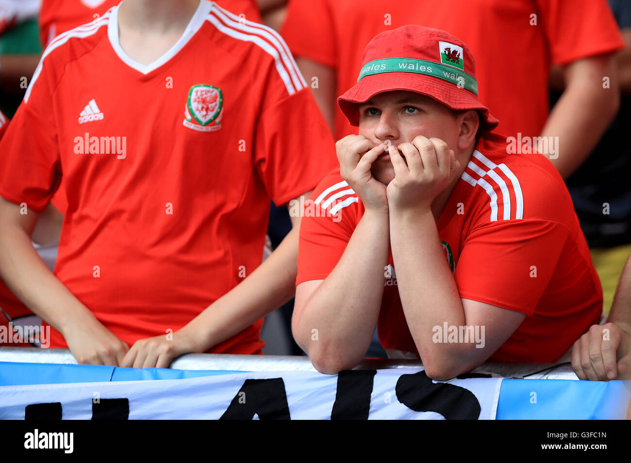 A Wales fan appears dejected after Slovakia's Ondrej Duda (not in picture) scores his side's first goal of the game during the UEFA Euro 2016, Group B match at the Stade de Bordeaux, Bordeaux. Stock Photo