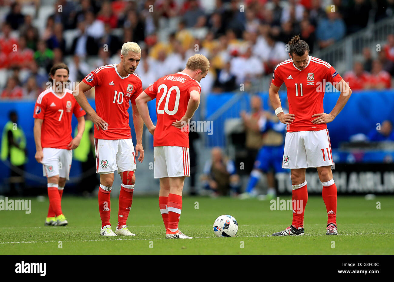 Wales' Aaron Ramsey (left), Wales' Jonathan Williams (centre) and Wales' Gareth Bale (right) appear dejected after Slovakia's Ondrej Duda (not in picture) scores his side's first goal of the game during the UEFA Euro 2016, Group B match at the Stade de Bordeaux, Bordeaux. Stock Photo