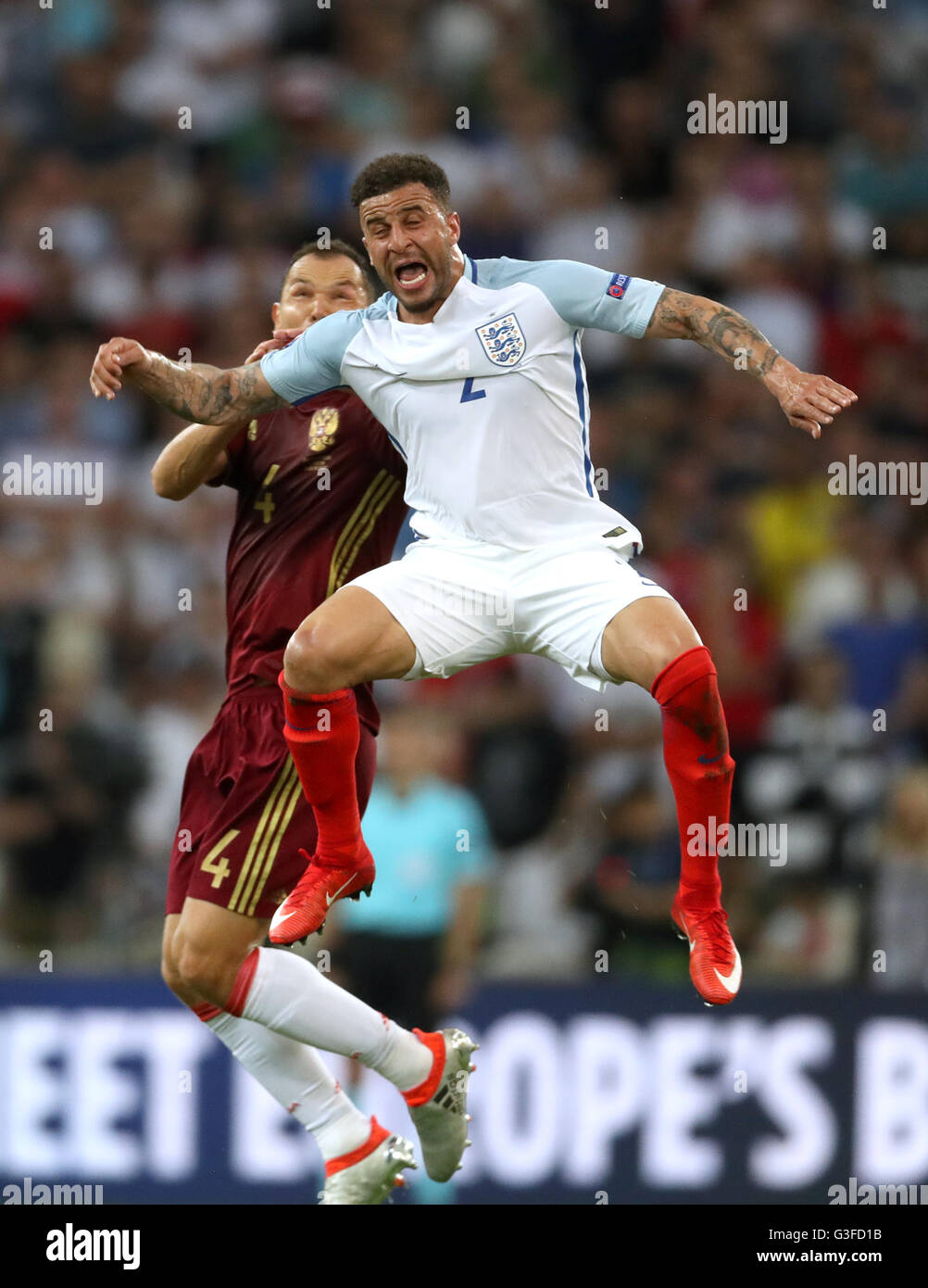 Russia's Sergei Ignashevich and England's Kyle Walker (right) battle for the ball in the air during the UEFA Euro 2016, Group B match at the Stade Velodrome, Marseille. Stock Photo