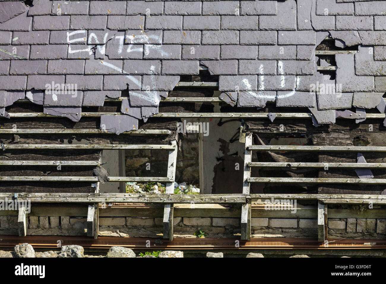 Derelict Buildiing with Enter sign through roof Stock Photo