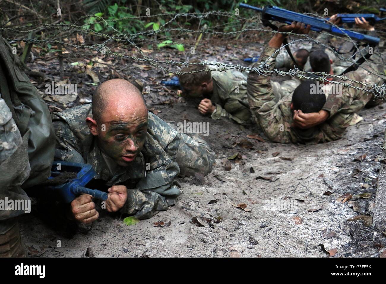 U.S. Army Soldiers Crawl Under Barbed Wire During The Team Obstacle ...