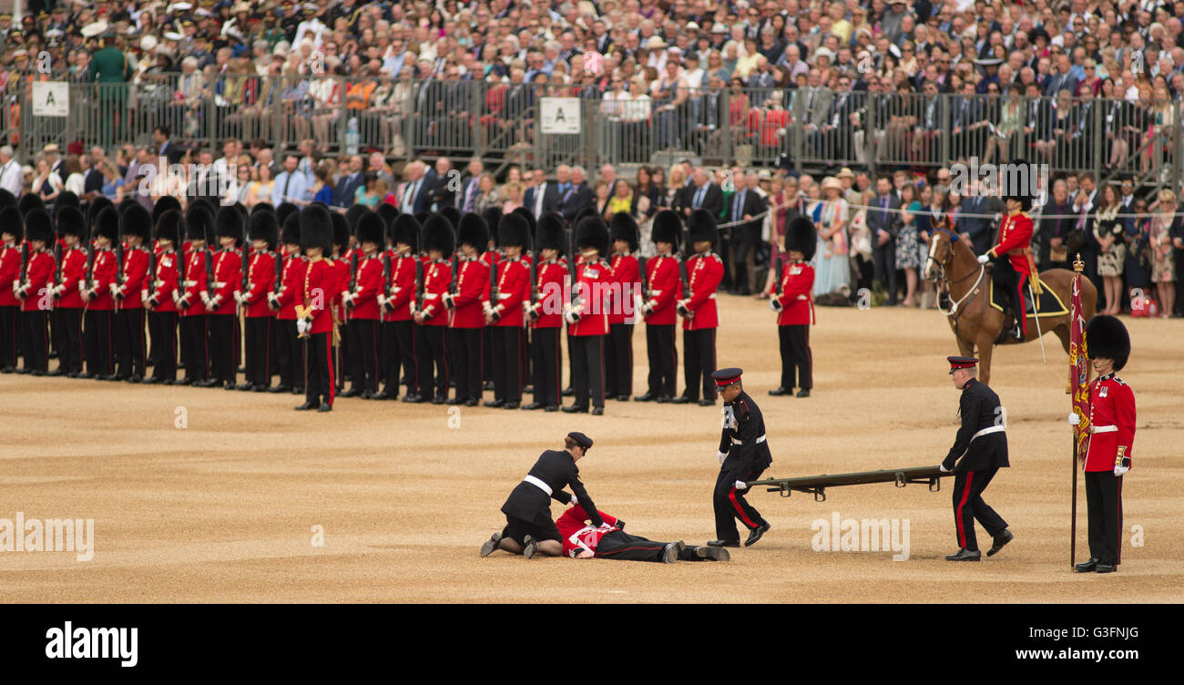 Trooping the Colour, Horse Guards Parade, London, UK. 11th June 2016. A soldier of the Colour Party collapses during the parade before the arrival of the Royal Procession and is stretchered off. Credit: Malcolm Park/Alamy Live News. Stock Photo