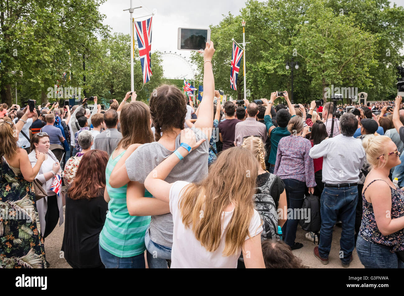 London, UK, 11th June 2016, Spectators line The Mall enjoying  the Trooping the Colour parade on the Queen's official 90th birthday. Stock Photo