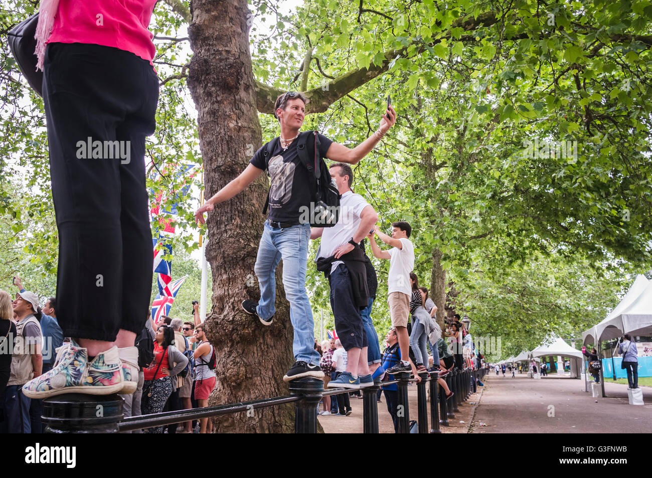 London, UK, 11th June 2016, A man takes a selfie as spectators line The Mall enjoying  the Trooping the Colour parade on the Queen's official 90th birthday. © Stock Photo