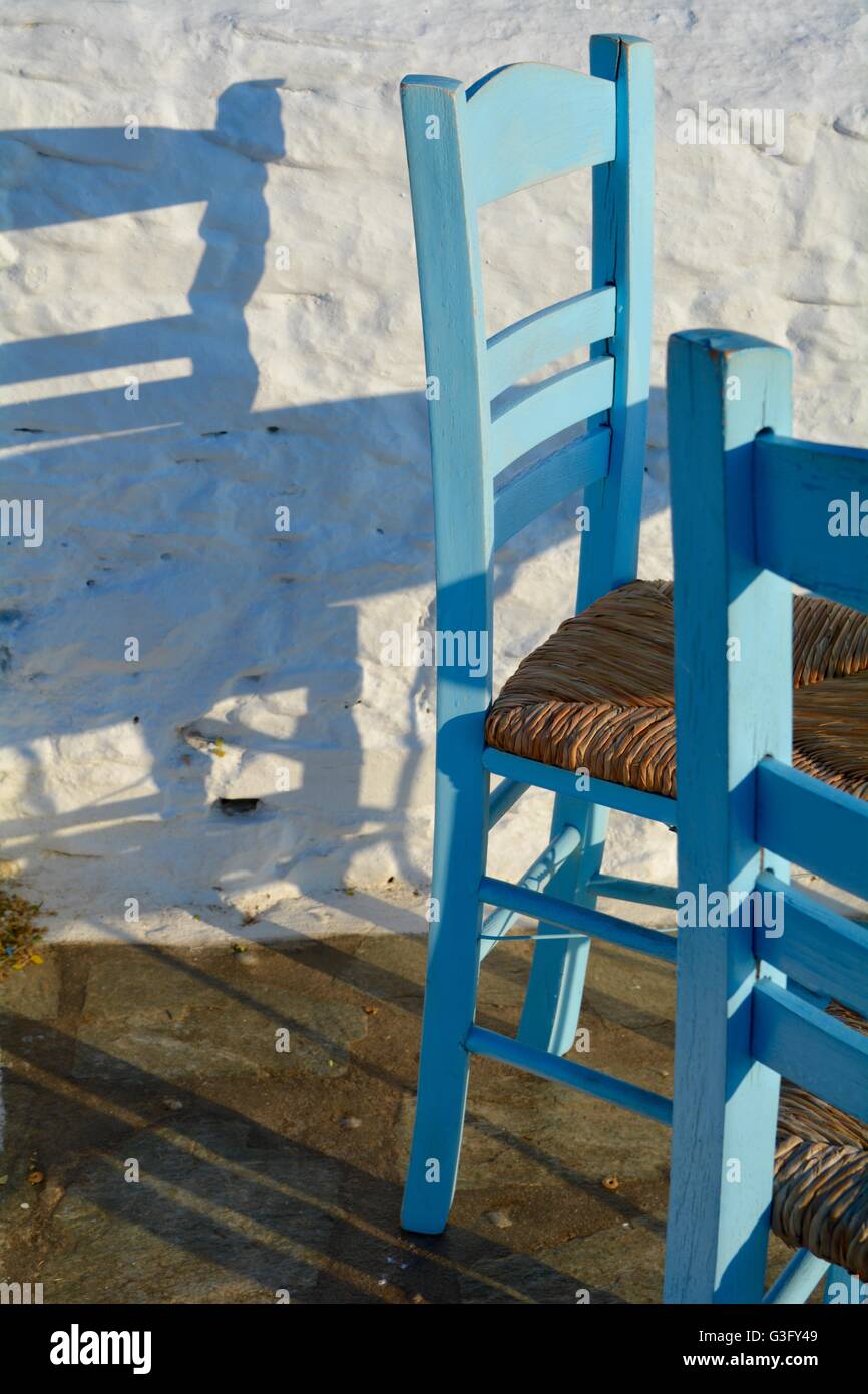 blue painted chairs and tables at a bar on the Greek island of Skopelos Stock Photo