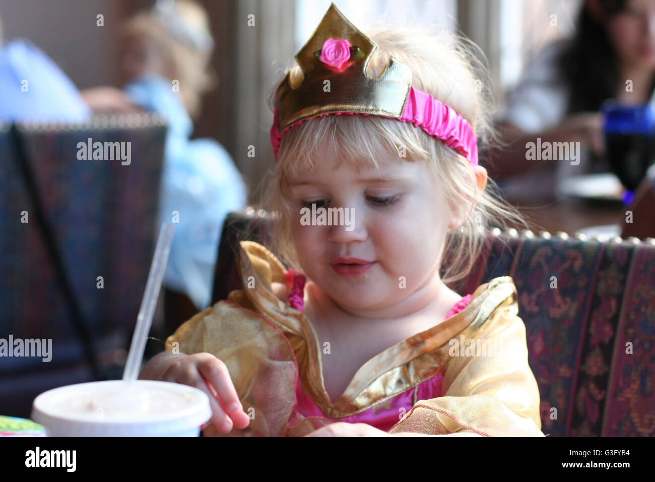 Little sweet blonde child kid, looking happy delighted in a princess costume Disney's Magic Kingdom, Disney World Florida USA, childhood memories Stock Photo