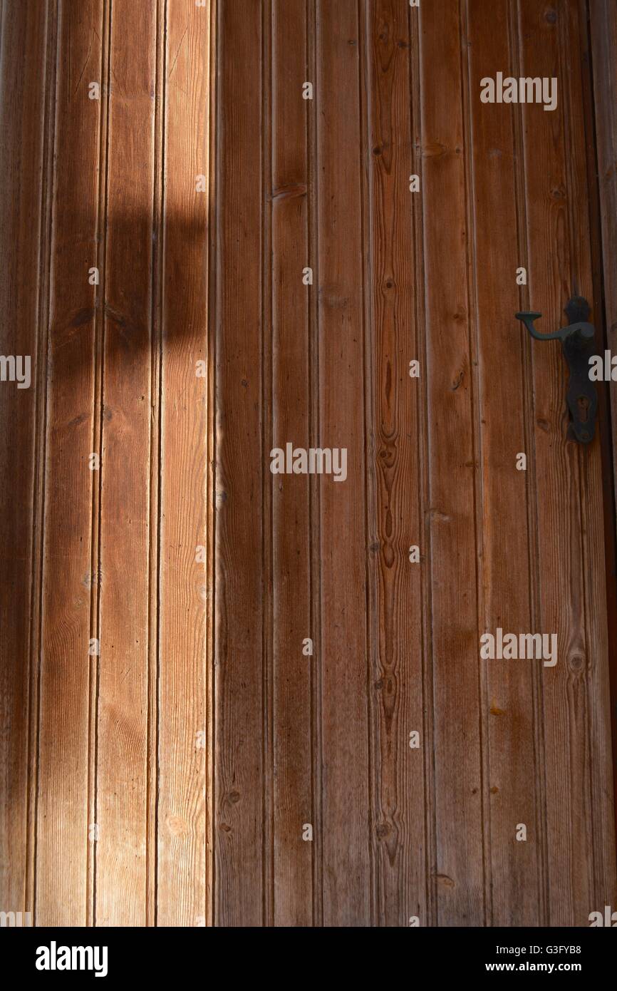 a wooden door in shadow in skopelos, greece Stock Photo