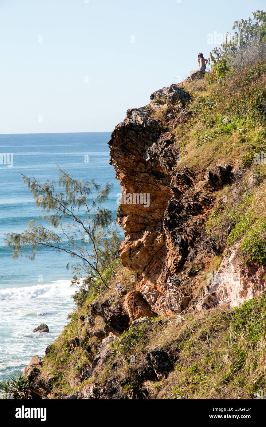 Two people on a cliff overlooking the Pacific Ocean on the Gold Coast in Australia Stock Photo