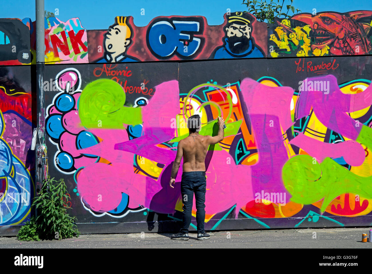 Graffiti artist working on the legal boards in New Street Edinburgh. Stock Photo