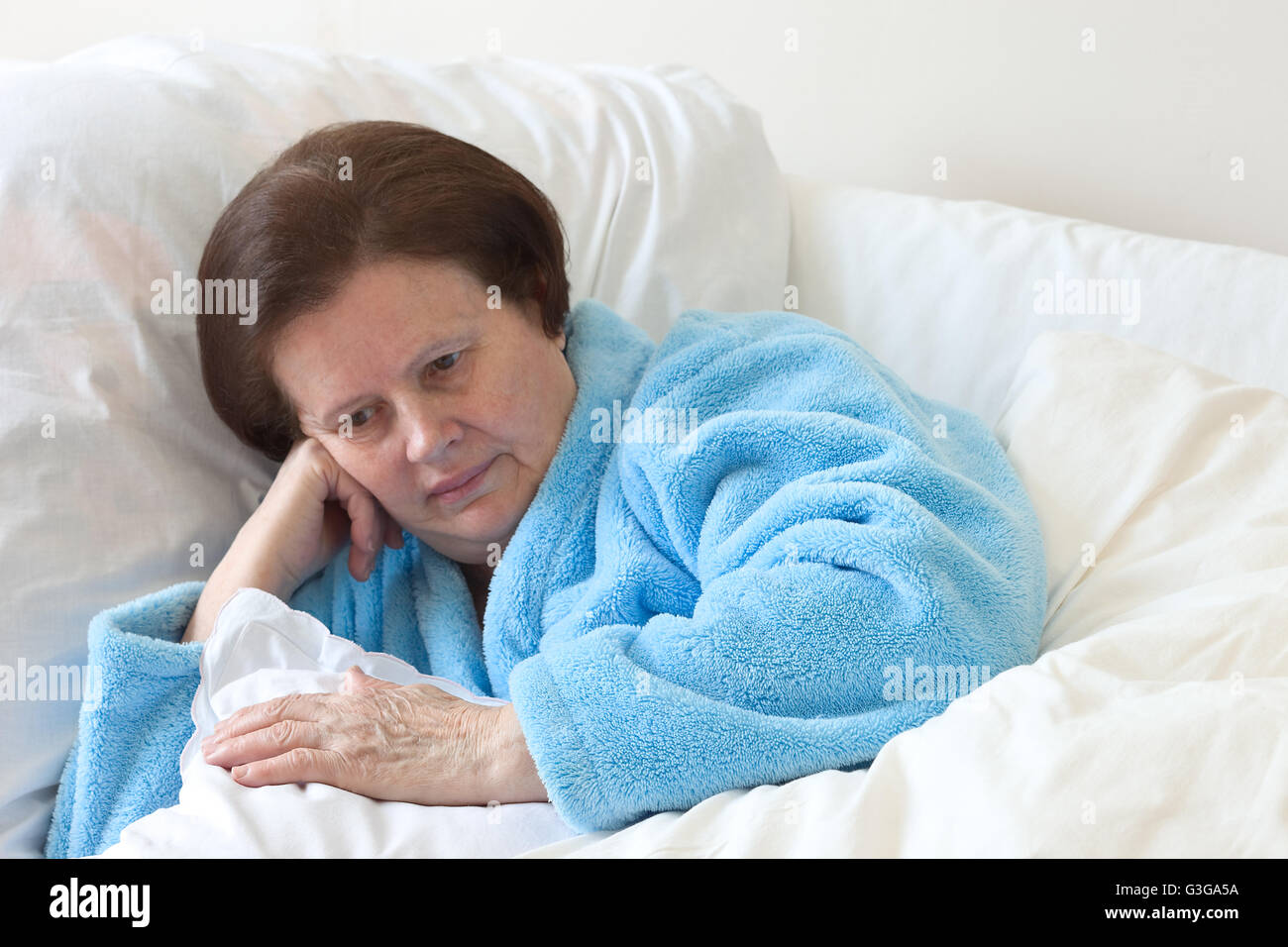 Sleeping elderly woman in a bed. Stock Photo