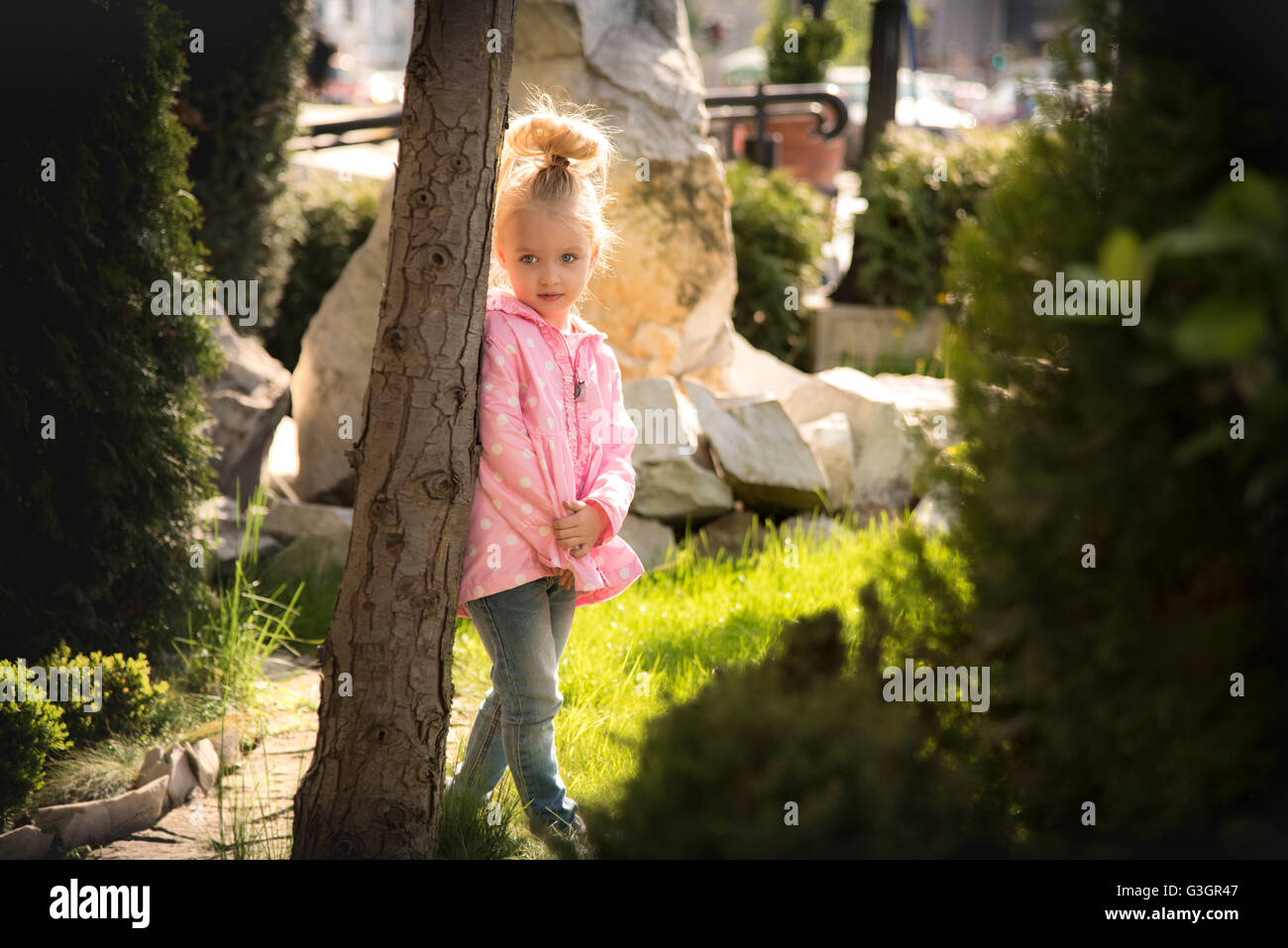 Blond little girl in park hi-res stock photography and images - Alamy
