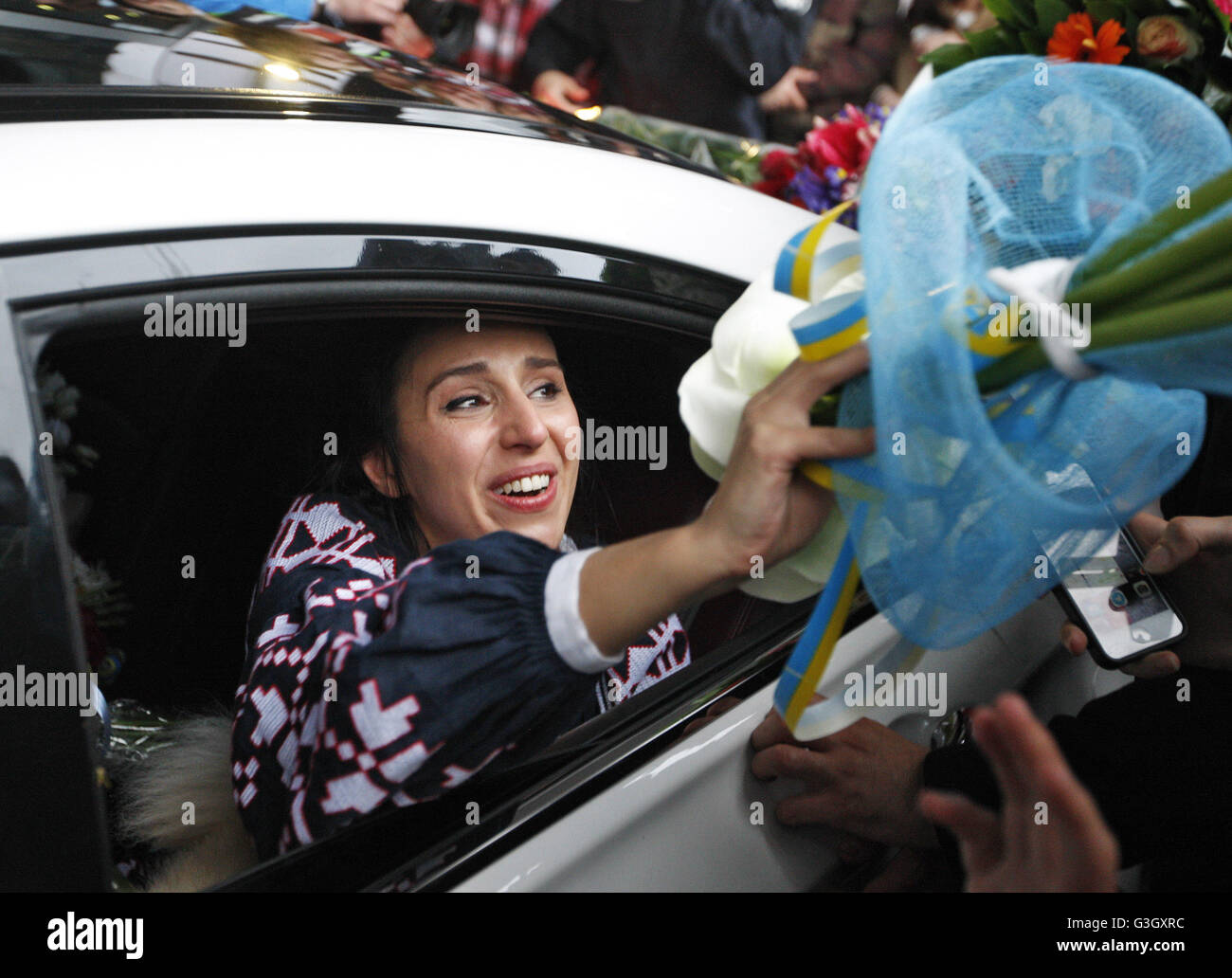 Kiev, Ukraine. 15th May, 2016. Ukrainian Crimean Tatar singer Jamala takes flowers from supporters after her arrival to the International airport Boryspil. Jamala won the 61st annual Eurovision Song Contest (ESC). © Vasyl Shevchenko/Pacific Press/Alamy Live News Stock Photo
