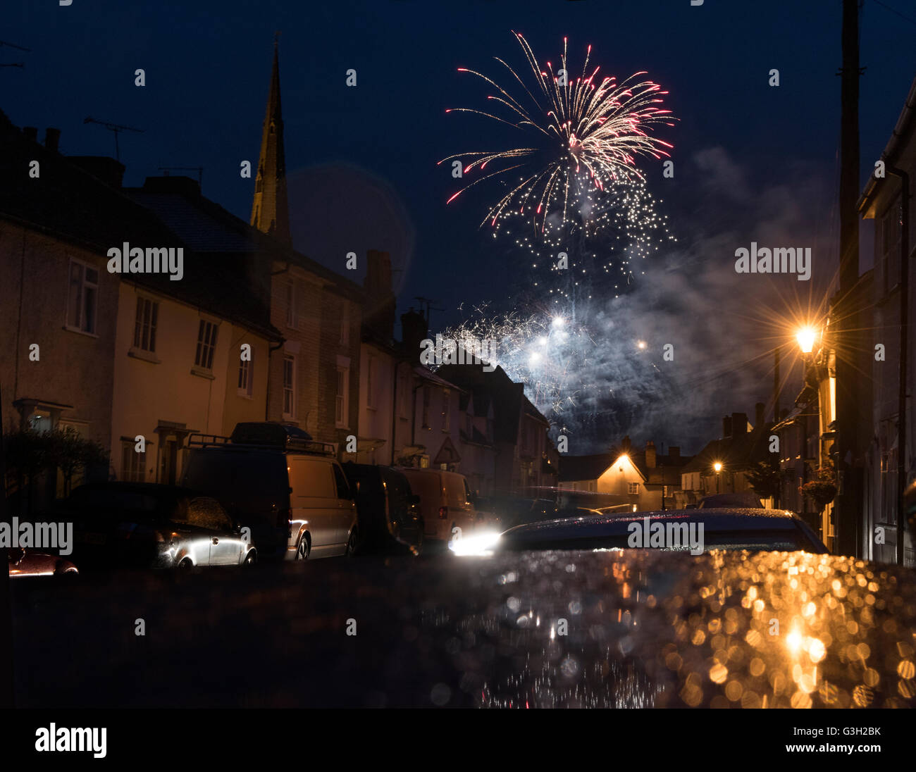 Thaxted, UK. 11th June, 2016. HM Queen Elizabeth II 0fficial 90th birthday celebration firework display in a rain storm, looking along 14th century Newbiggen Street towards Thaxted Church, Thaxted Essex, England UK. 11 June 2016 Credit:  BRIAN HARRIS/Alamy Live News Stock Photo