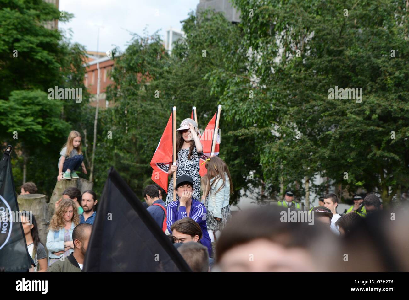 London, UK. 24 June, 2016. Pro-europe and migrant rally held in London.  A young girl stands with the anti-fascist flag. Credit:  Marc Ward/Alamy Live News Stock Photo