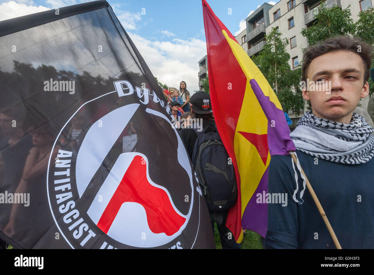 London, UK. June 24th 2016. Anti-fascist protesters with flags, including a Spanish Republican flag at the rally in Altab Ali Park on the day after the UK voted to leave the EU against racism, for migrant rights and against fascist violence. They say that migration and immigrants have been attacked and scapegoated not only by both Remain and Leave campaigns but by mainstream parties and media over more than 20 years, stoking up hatred by insisting immigrants are a 'problem'.Peter Marshall/Alamy Live News Stock Photo