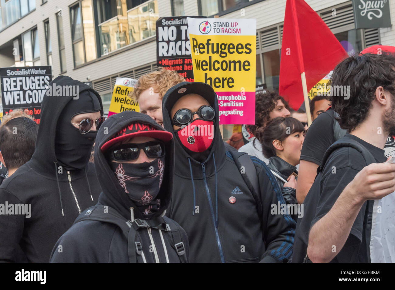 London, UK. June 24th 2016. Protesters, including a group dressed in black and masked march from the rally in Altab Ali Park to the offices of News International on the day after the UK voted to leave the EU. They were protesting against racism, for migrant rights and against fascist violence and argue that migration and immigrants have been attacked and scapegoated not only by both Remain and Leave campaigns but by mainstream parties and media over more than 20 years, stoking up hatred by insisting immigrants are a 'problem'. Peter Marshall/Alamy Live News Stock Photo