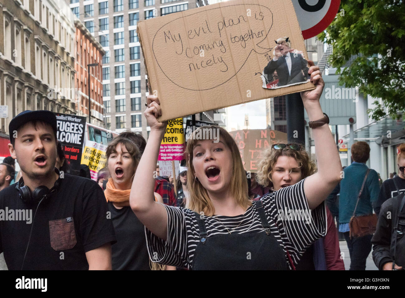 London, UK. June 24th 2016. Protesters, including a woman holding up a poster with Boris as a devil', march from the rally in Altab Ali Park to the offices of News International on the day after the UK voted to leave the EU. They were protesting against racism, for migrant rights and against fascist violence and argue that migration and immigrants have been attacked and scapegoated not only by both Remain and Leave campaigns but by mainstream parties and media over more than 20 years, stoking up hatred by insisting immigrants are a 'problem'. Peter Marshall/Alamy Live News Stock Photo