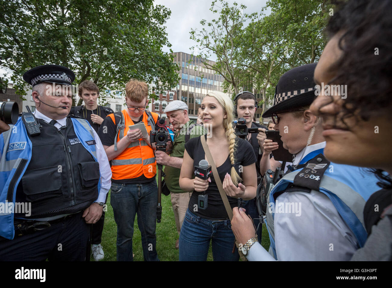 London, UK. 24th June, 2016. Lauren Southern(C), a Canadian libertarian commentator and contributor for the newsgroup: The Rebel reports from 'Defend All Migrants' post-Brexit protest. A post EU referendum protest led by over five hundred pro-refugee protesters and anti-government anarchist groups marched from Aldgate in east London to News UK HQ in London Bridge Credit:  Guy Corbishley/Alamy Live News Stock Photo