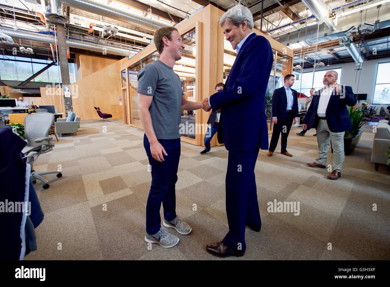 U.S. Secretary of State John Kerry greets Facebook CEO Mark Zuckerberg before their meeting at Facebook's new headquarters June 23, 2016 in Menlo Park, California. Kerry used his left hand as Zuckerberg is recovering from a broken right arm. Stock Photo