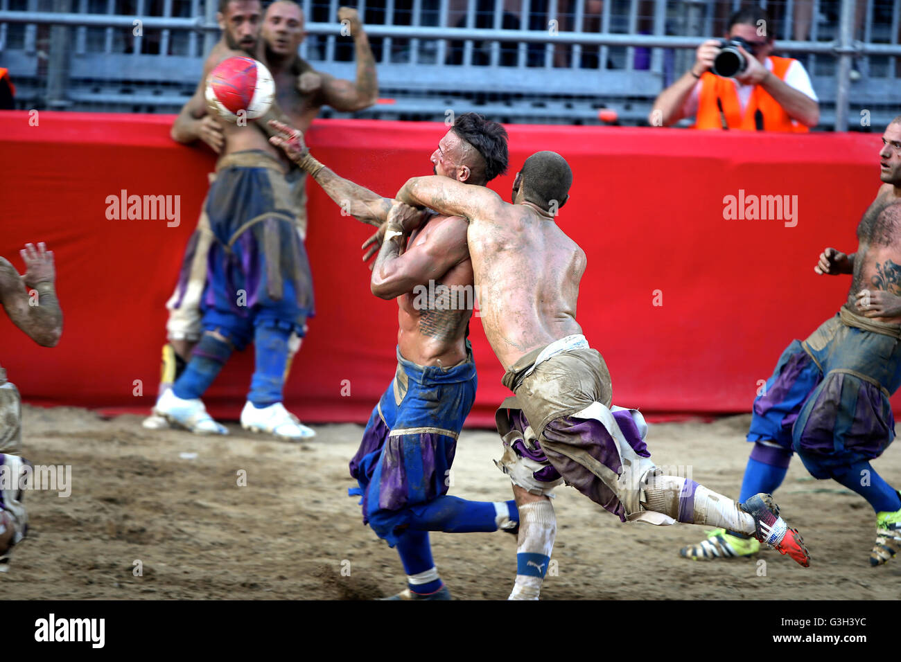 Florence, Italy. 24th June, 2016. (A Santo Spirito Bianchi player (white)  fights against a La Santa Croce Azzuri player during the Calcio Fiorentino  (historic football) final match in Santa Croce square, Florence.