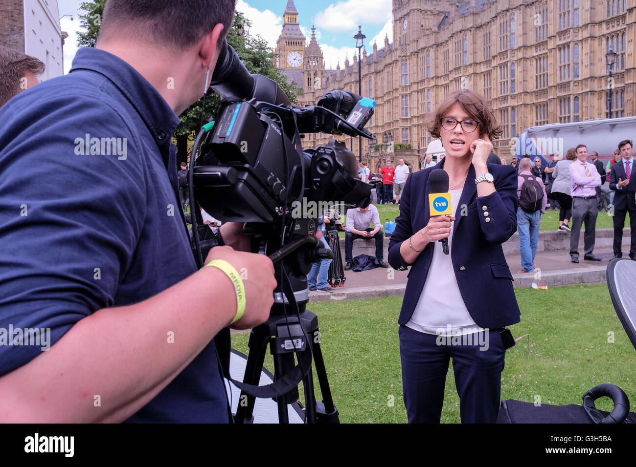 London, UK. 24 June 2016 Television news reporter from Polish channel TVN presents piece live to camera opposite Houses of Parliament following the result of UK referendum on EU membership. Stock Photo