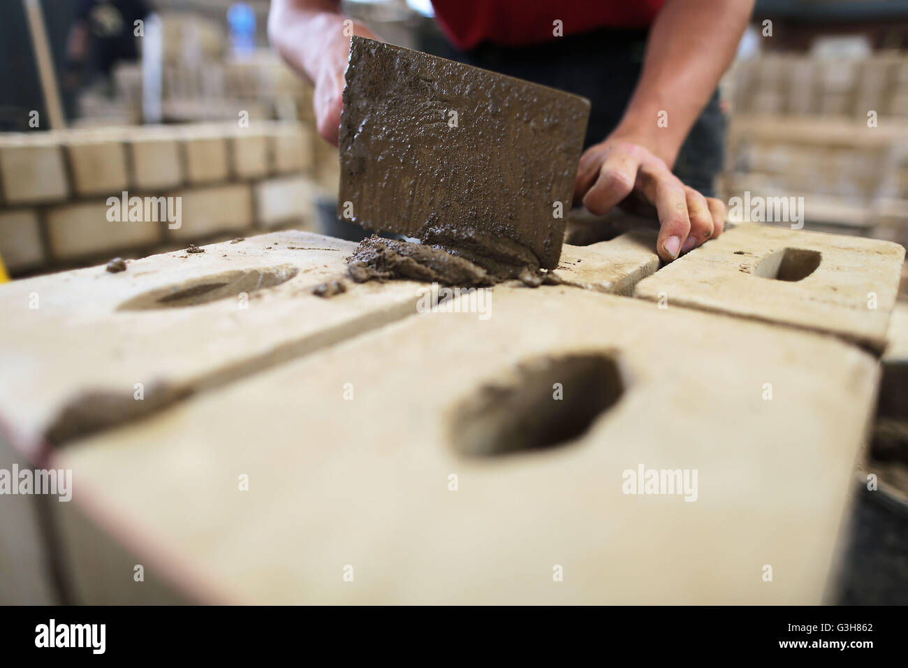 Trainees work on a wall at the training centre Butzweilerhof in Cologne, germany, 21 June 2016. Photo: Oliver Berg/dpa Stock Photo