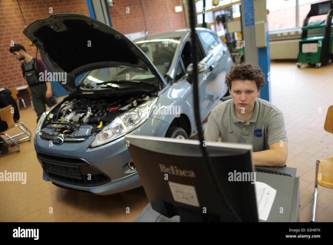 An automotive mechatronics engineer trainee works on a car at the training centre Butzweilerhof in Cologne, germany, 21 June 2016. Photo: Oliver Berg/dpa Stock Photo