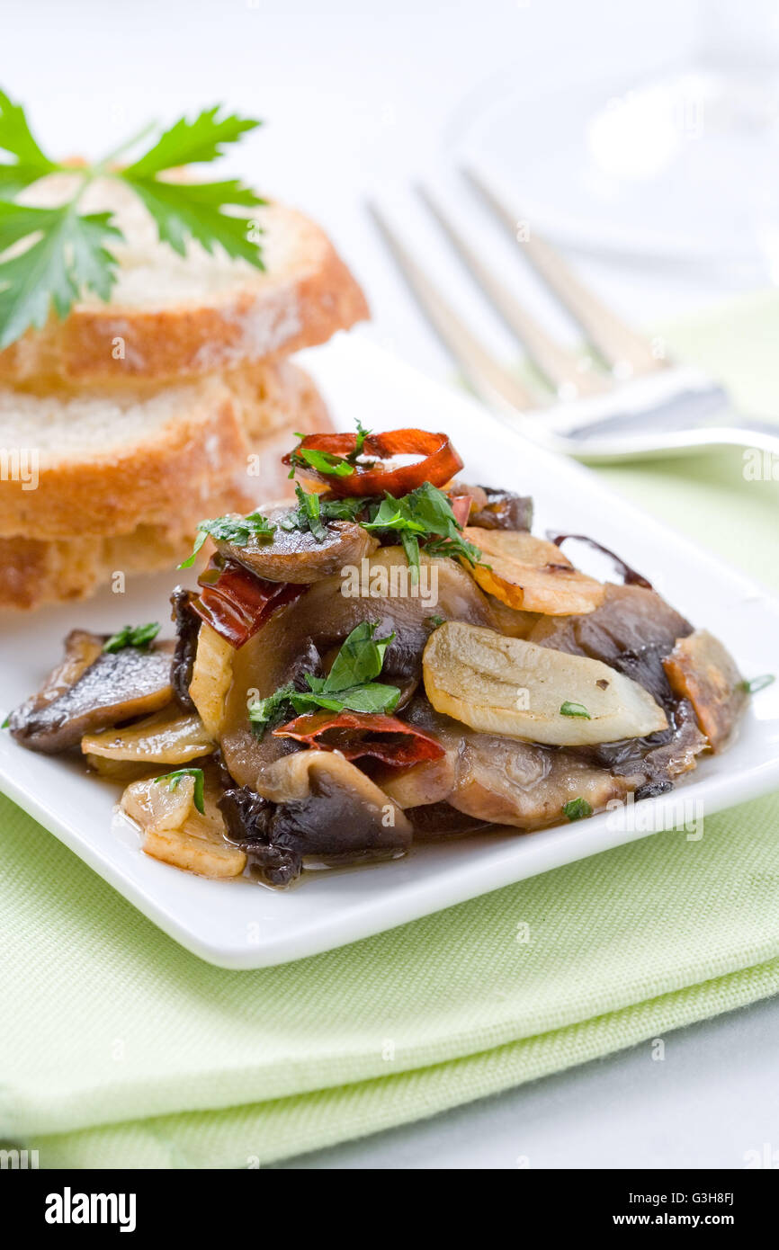 Mushroom appetizer with garlic, parsley and chili pepper Stock Photo