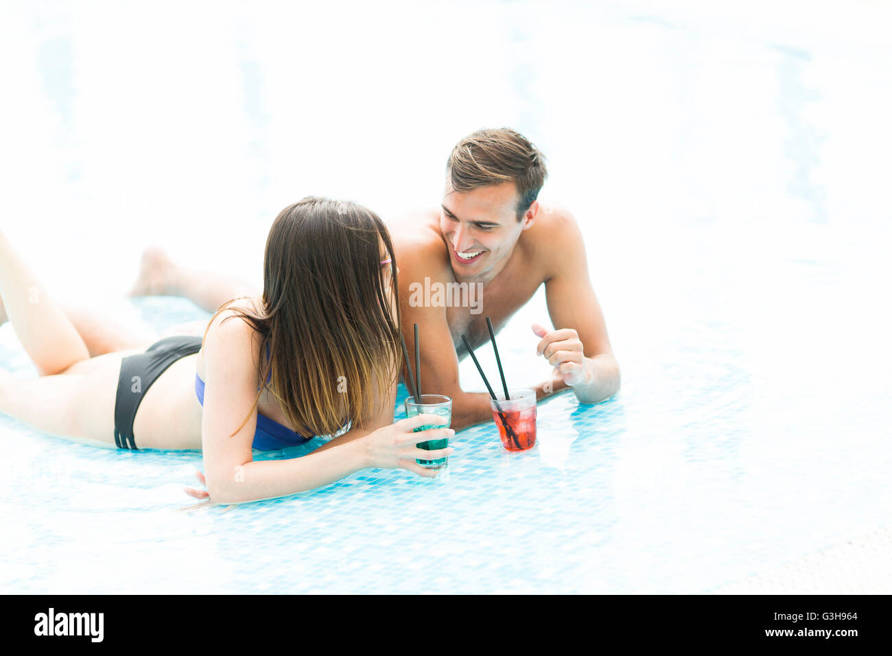 Couple in the pool in the summertime Stock Photo