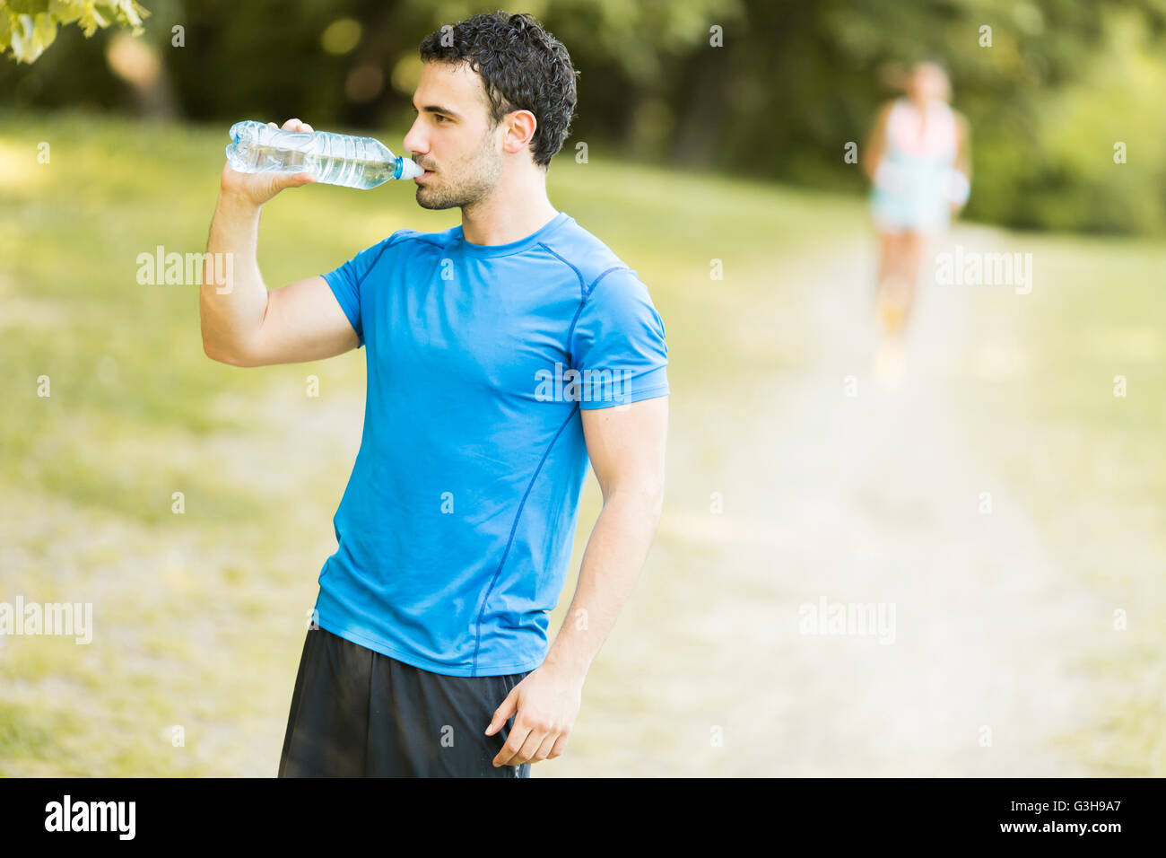 Athletic sport man drinking water from a bottle Stock Photo Alamy