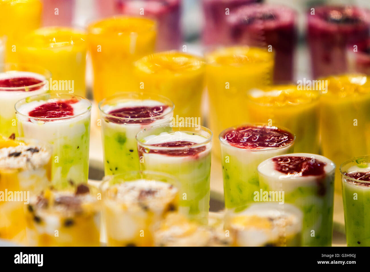 Frozen fruit smoothies with fresh blended different fruits served in