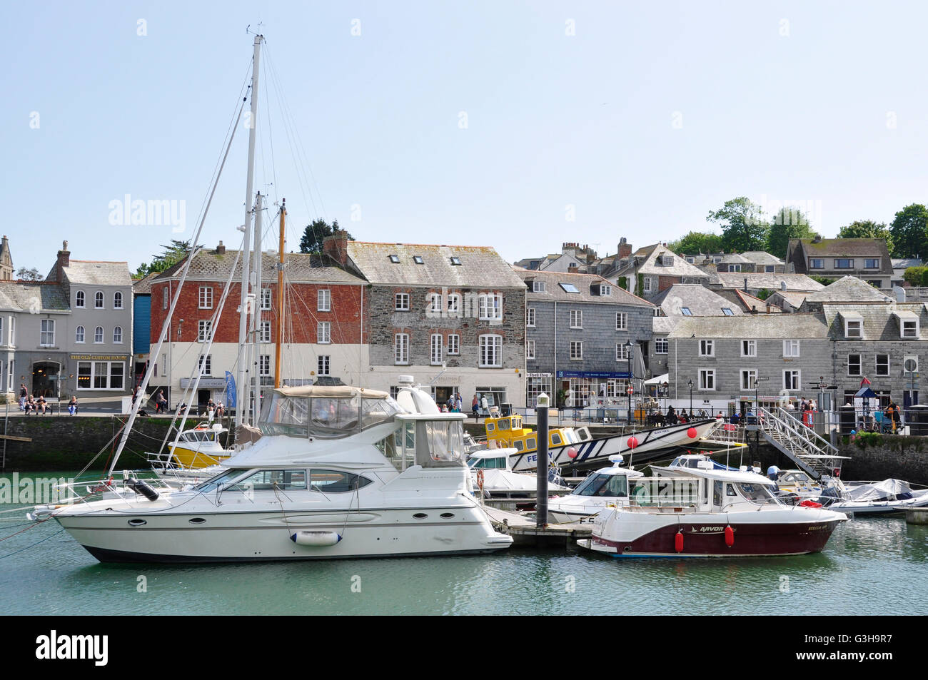 Padstow harbour boats at anchor backdrop period town buildings