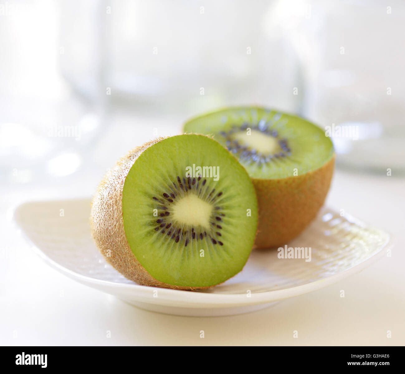 Kiwi Fruit Cut In Half Isolated On A Plate Stock Photo Alamy   Kiwi Fruit Cut In Half Isolated On A Plate G3HAE6 