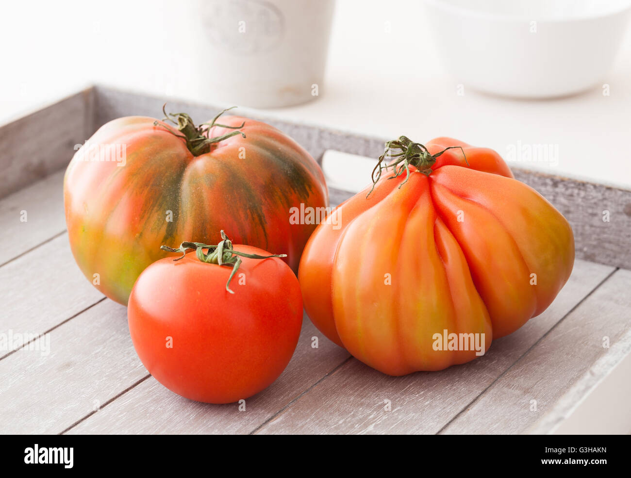 Three different organic heirloom tomatoes from Spain. Stock Photo
