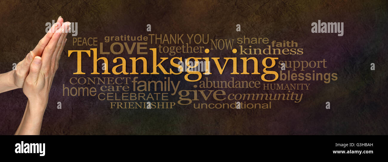 Female praying hands beside the word THANKSGIVING surrounded by a word cloud on a warm brown rustic stone background Stock Photo