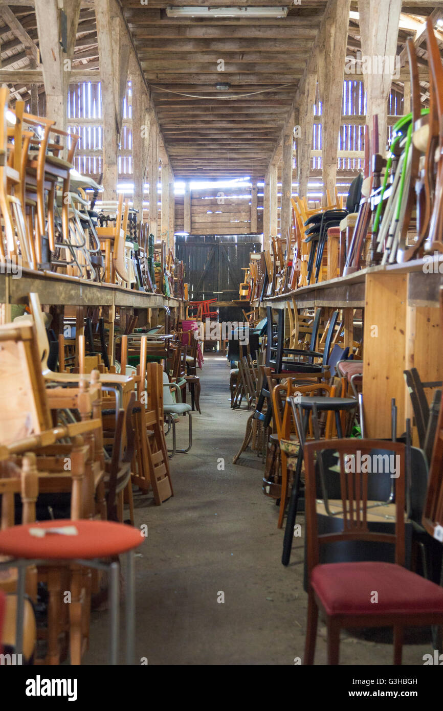 Large antique furniture warehouse inside an old barn, Södermanland, Sweden Stock Photo