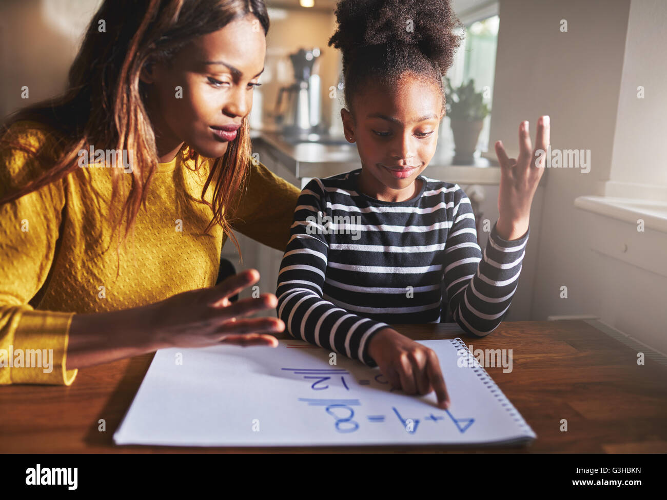Mother learning child to calculate, black mother and daughter Stock Photo