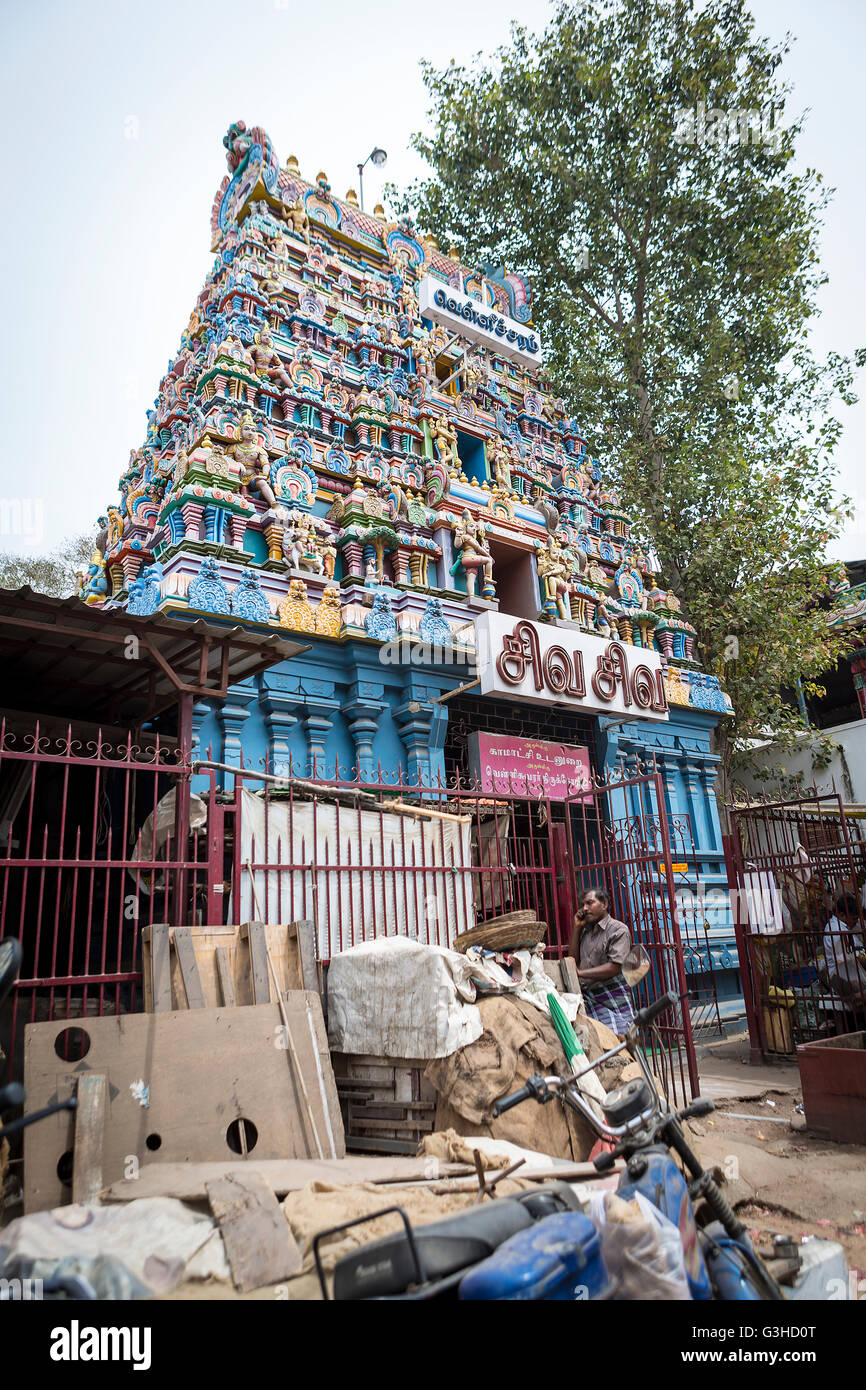 Indian Temple with a pile of rubbish outside the boundary fence Stock Photo