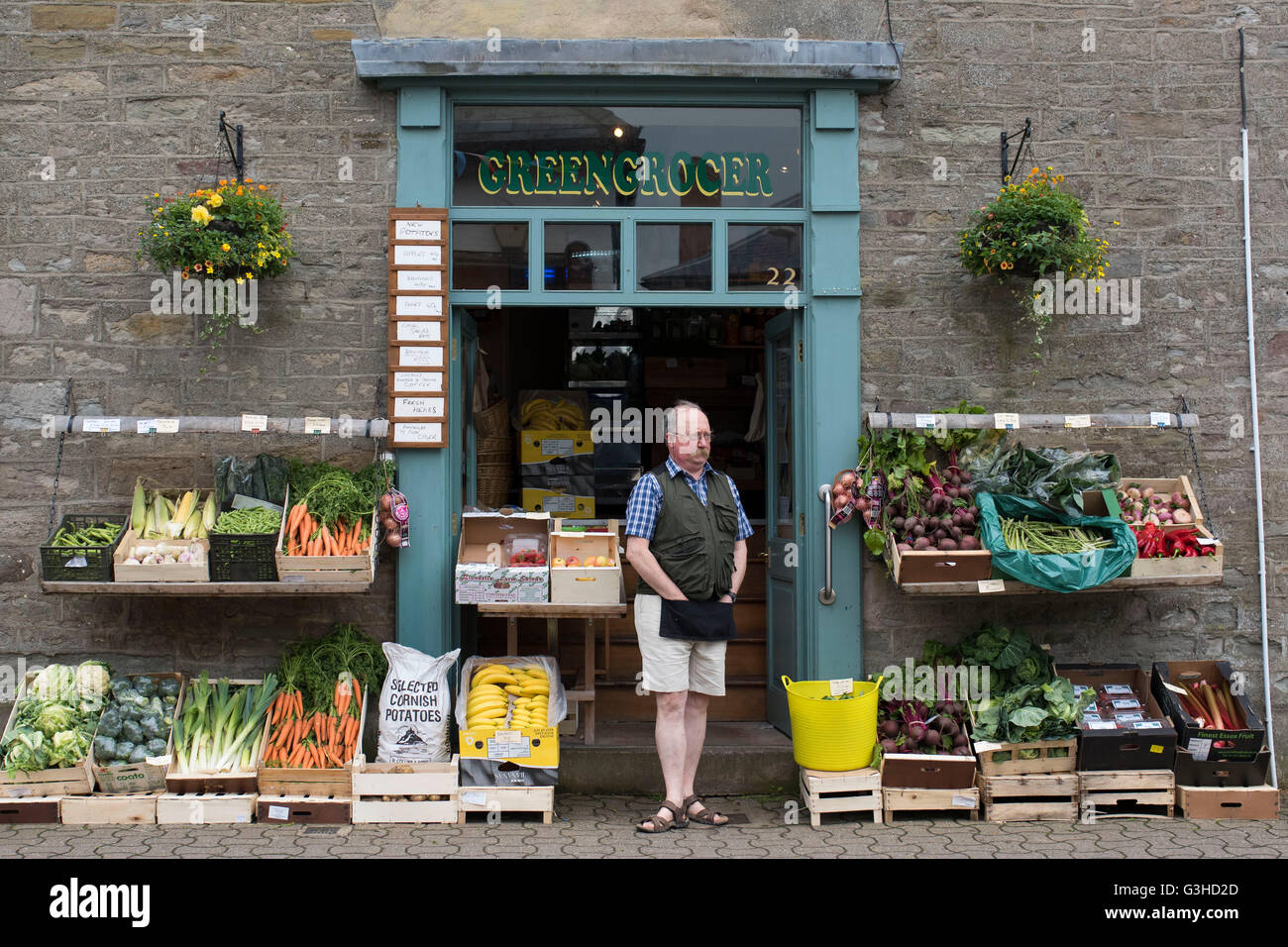 A traditional greengrocer selling healthy fruit and vegetables on the street in Hay-on-Wye, Wales. Stock Photo