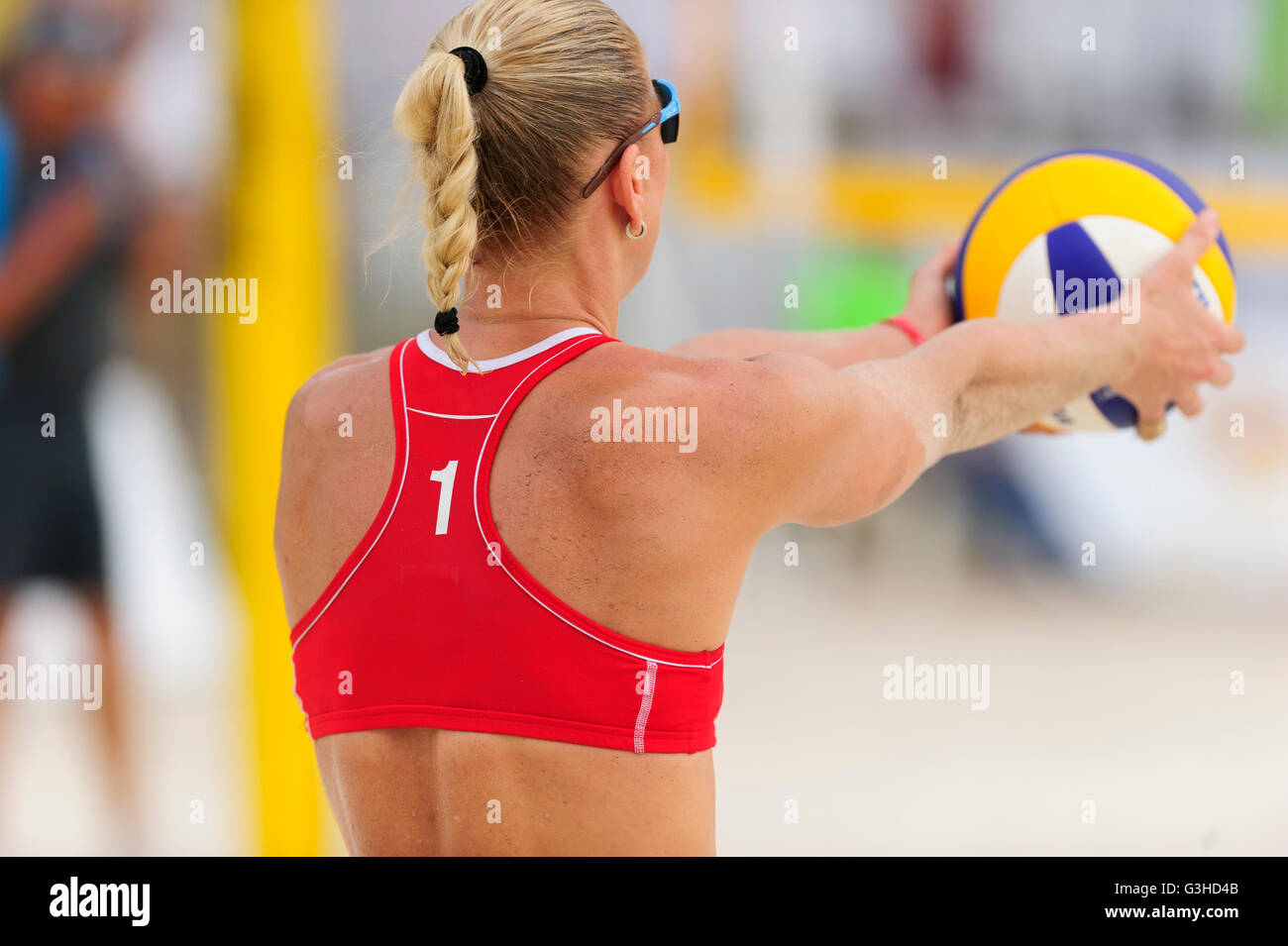 Volleyball player is a female athlete volley ball player getting ready to serve the ball. Stock Photo