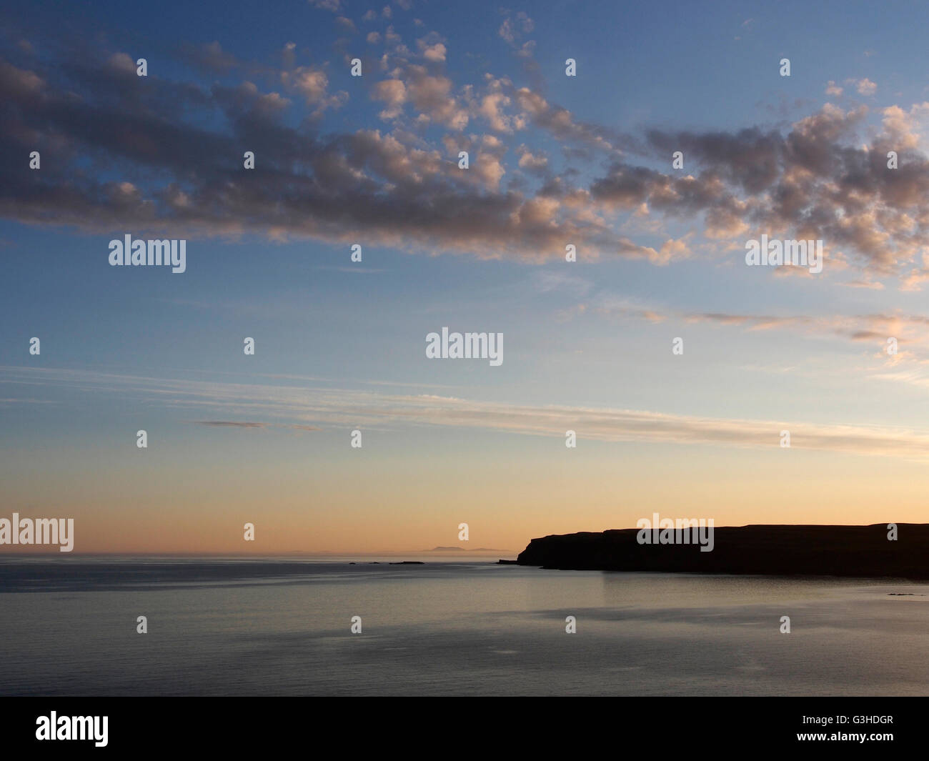 Sunset view towards a distant Barra from Sanday, Canna, Scotland Stock Photo