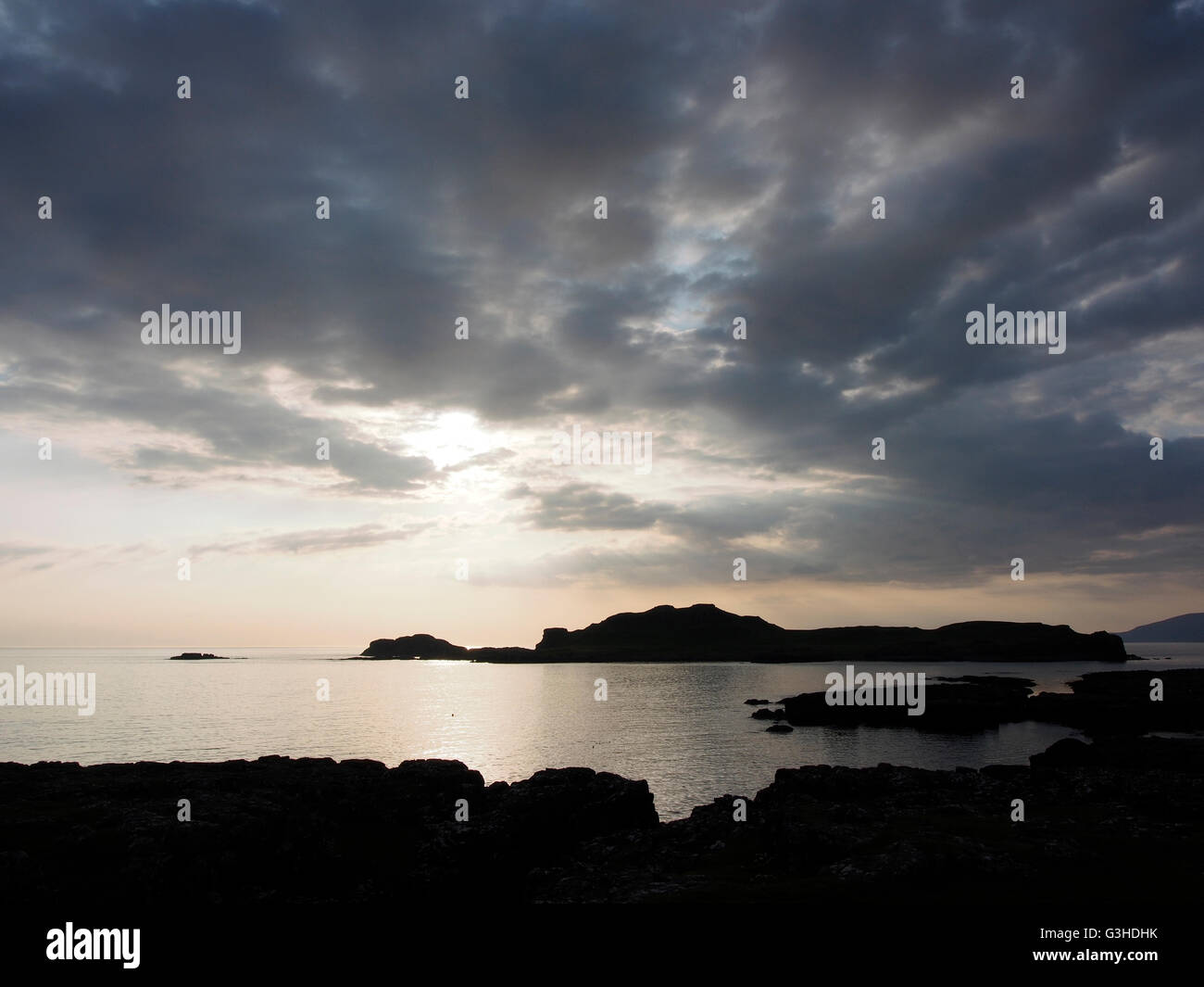 Sunset over Eilean nan Each (Horse island) from Muck, Scotland Stock Photo
