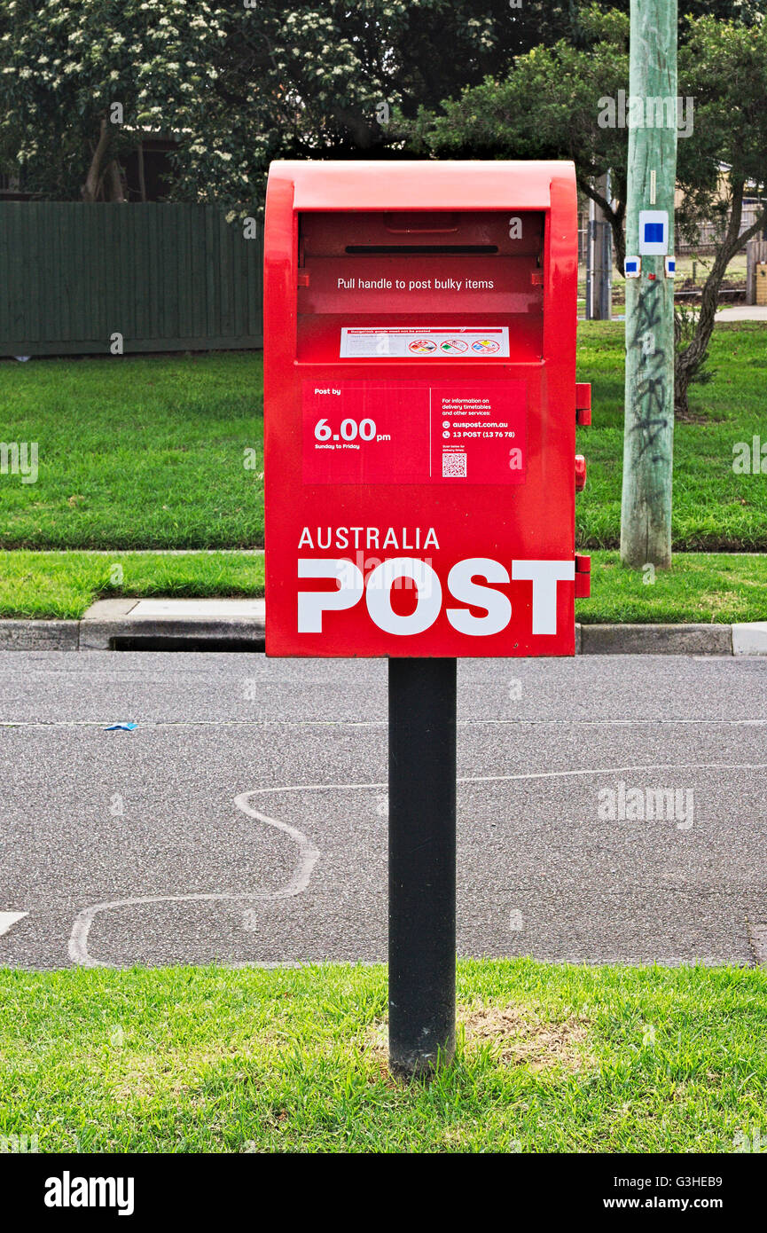 Red Australia Post mail box on a suburban Melbourne street. Stock Photo