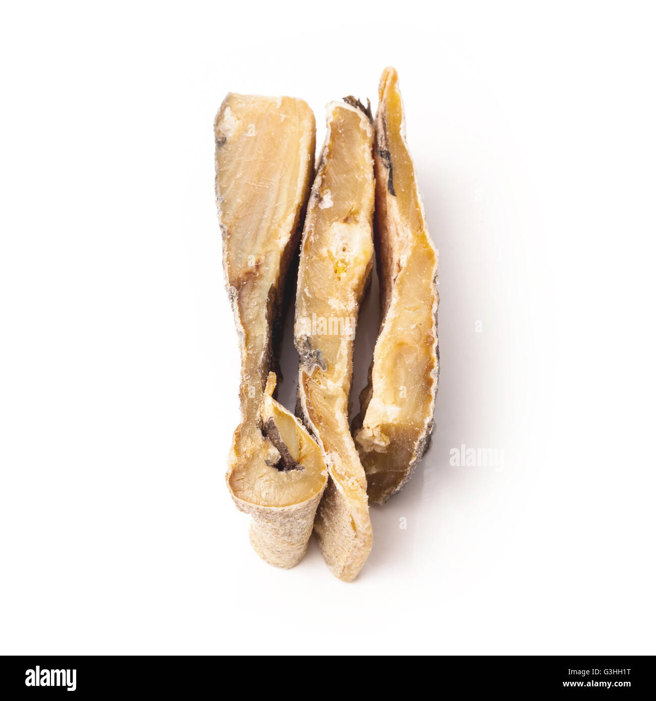 Portuguese Bacalhau traditional salt dried cod, isolated on a white studio background. Stock Photo