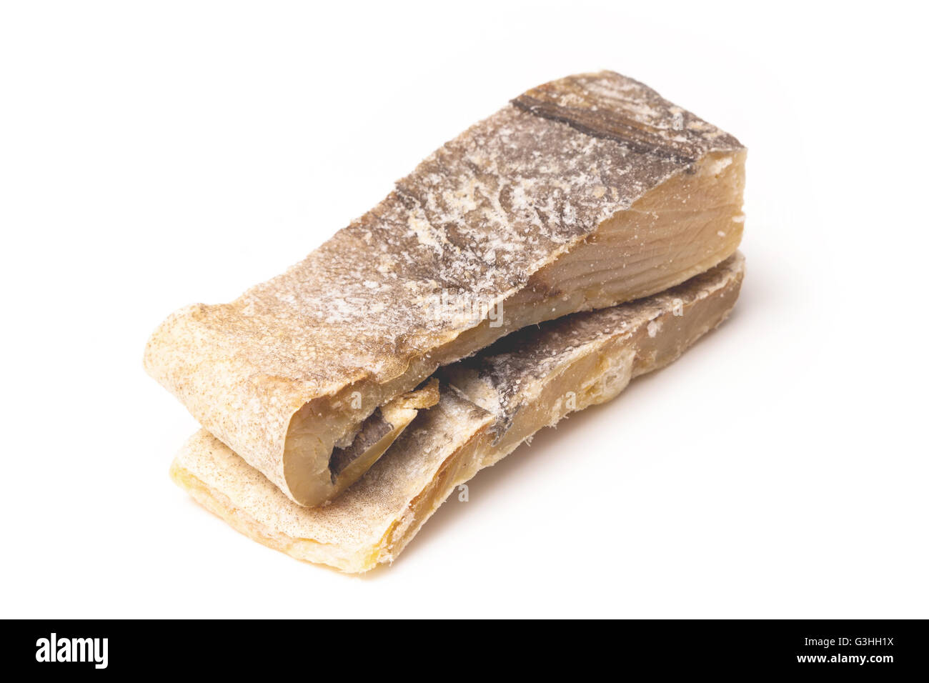 Portuguese Bacalhau traditional salt dried cod, isolated on a white studio background. Stock Photo