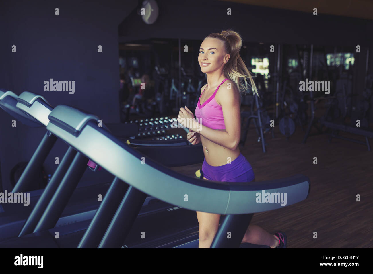 Fitness girl running on treadmill Stock Photo Alamy