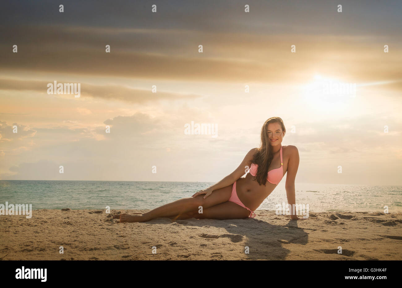 Portrait of young woman wearing bikini relaxing on Miami beach, Florida, USA Stock Photo