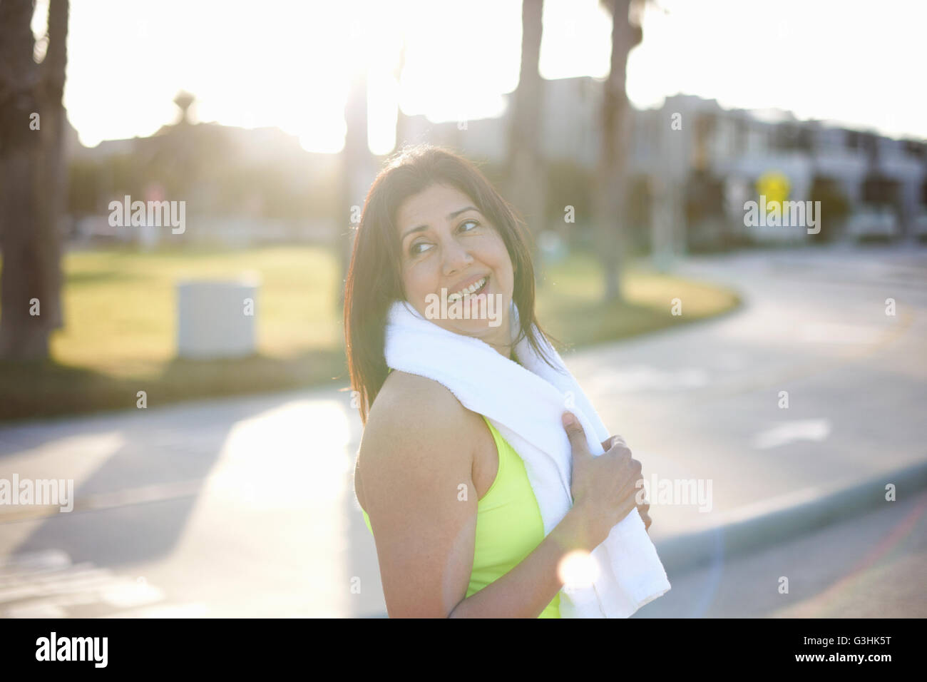 Woman towel on shoulders looking away over shoulder Stock Photo Alamy