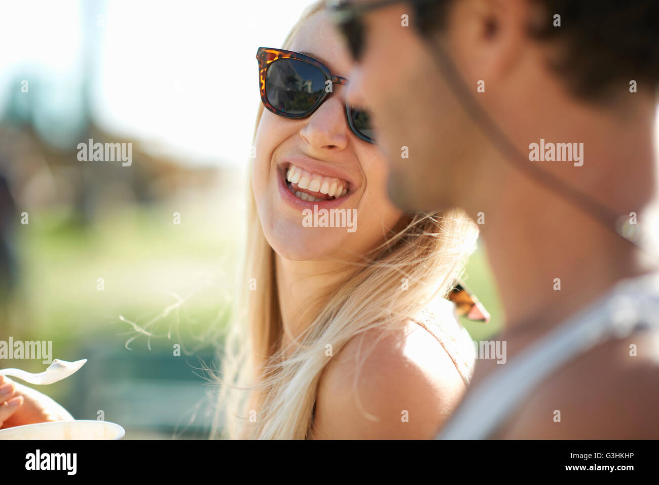 Close up of couple eating frozen yoghurt at Venice Beach, California