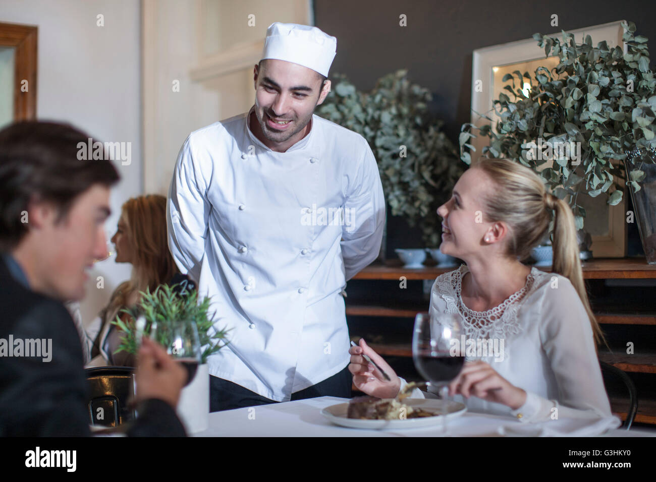 Chef chatting with customers in restaurant Stock Photo 105495012 Alamy